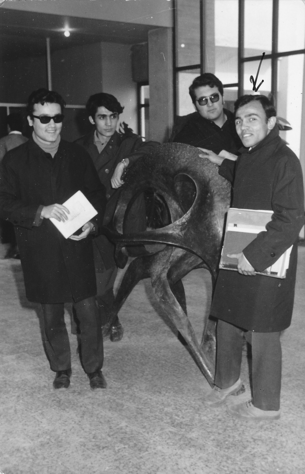 Students pose in front of the abstract deer sculpture in the library (1966)