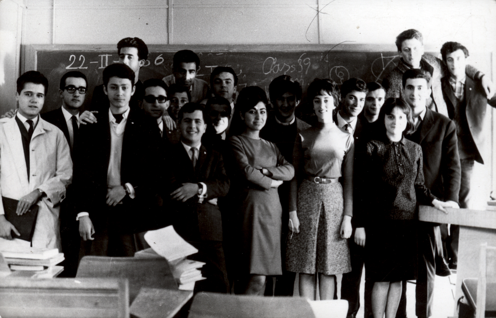 Students having their photos taken in front of the blackboard (1966)