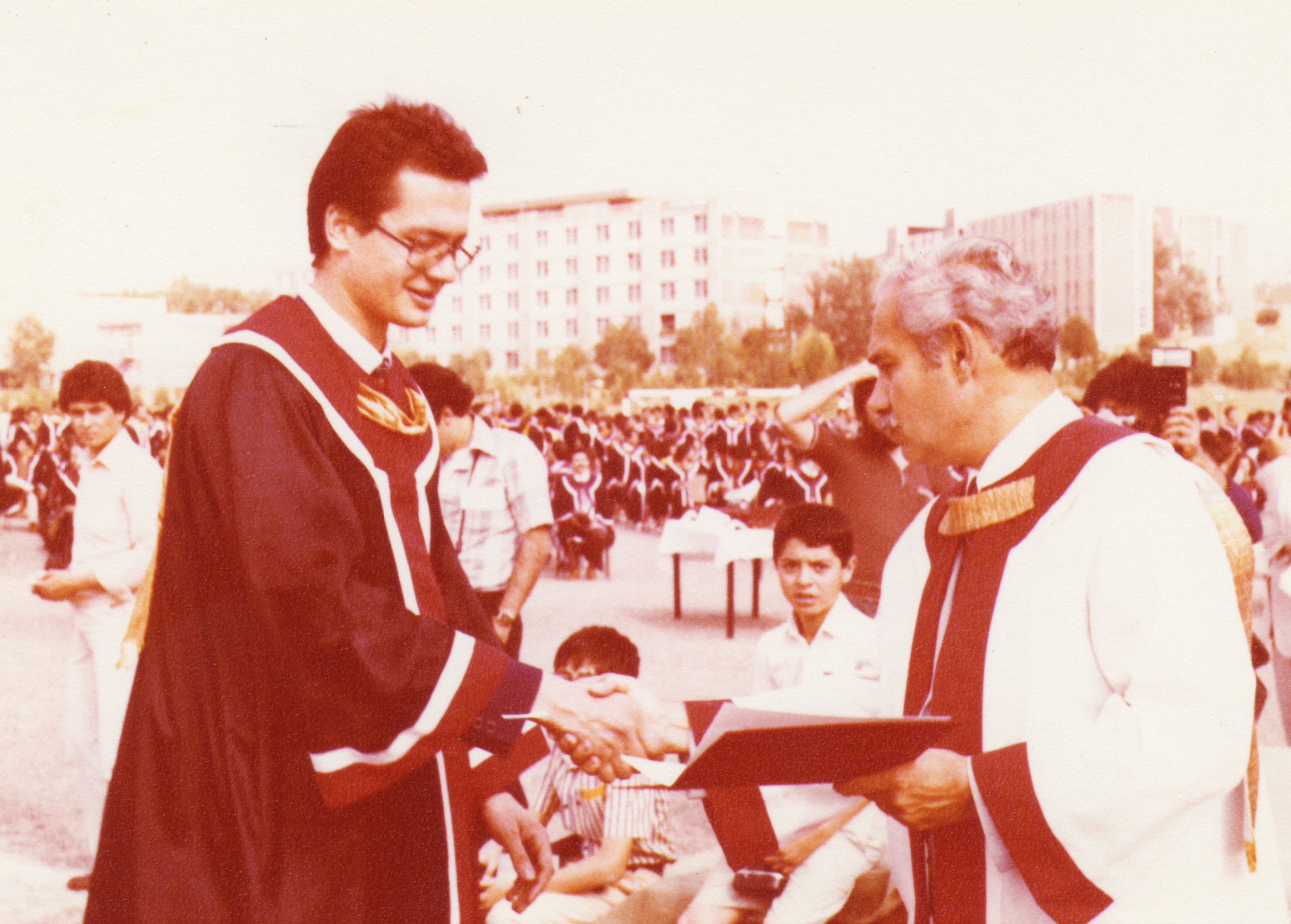 Güney Özcebe receiving his diploma from Rector Mehmet Kıcıman (1980)